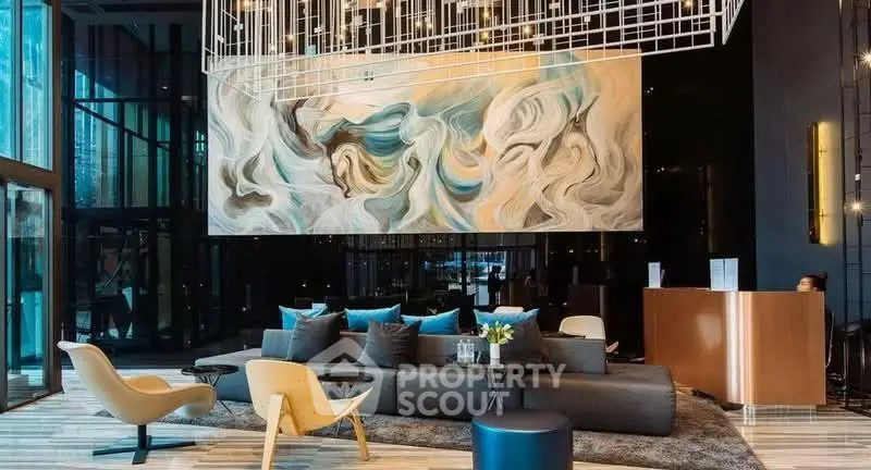 Luxurious modern lobby with artistic decor and elegant seating area in upscale building.