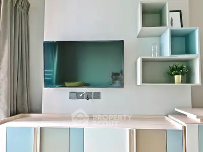 Modern living room with wall-mounted TV and stylish shelving