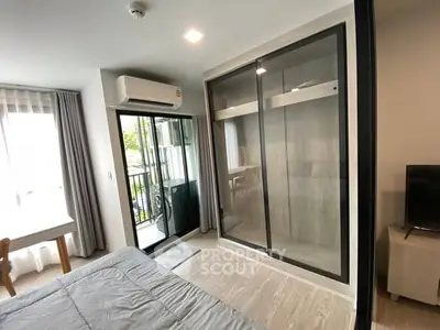 Modern bedroom with balcony access and sleek wardrobe design