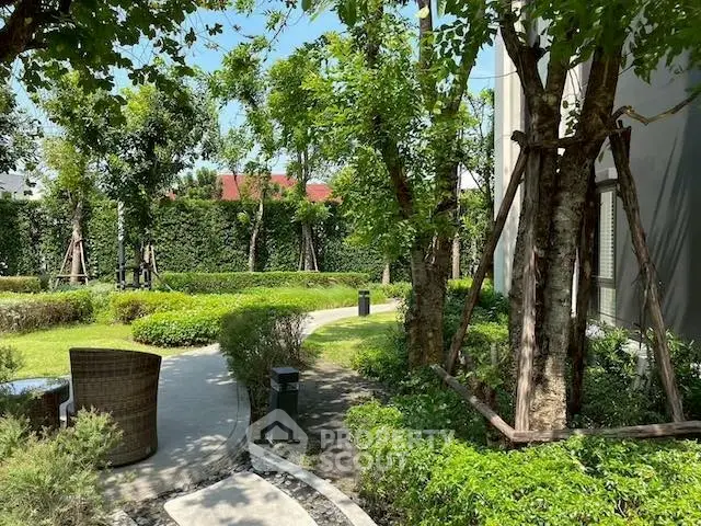 Lush garden view with winding path and mature trees in a serene residential setting.
