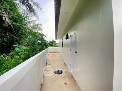 Spacious outdoor corridor with lush greenery and modern design