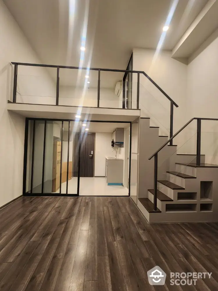 Modern loft apartment with mezzanine and sleek wooden flooring