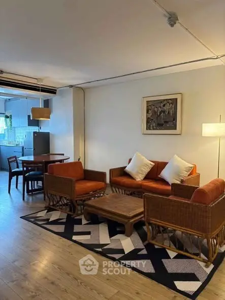 Charming living room with cozy seating and stylish decor in a modern apartment.