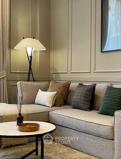 Elegant living room with stylish grey sofa and modern lamp