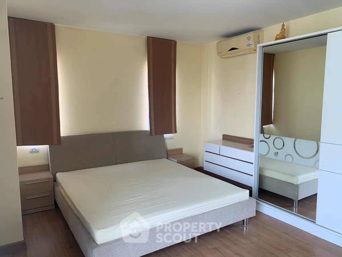 Spacious bedroom with modern furniture and ample natural light