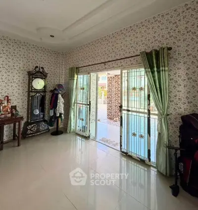 Spacious living room with elegant decor and large windows opening to a beautiful outdoor view.