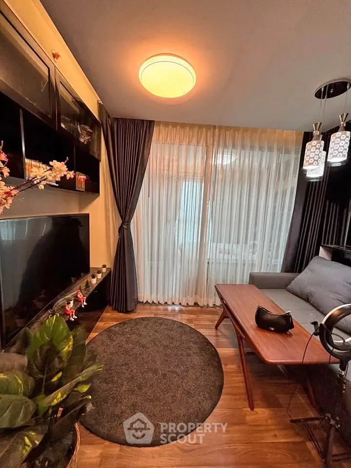Modern living room with stylish decor, large TV, and cozy seating area, perfect for relaxation and entertainment.