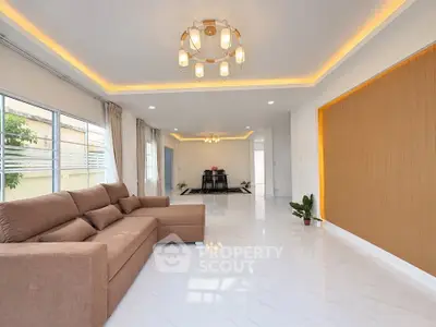 Spacious modern living room with elegant lighting and large windows