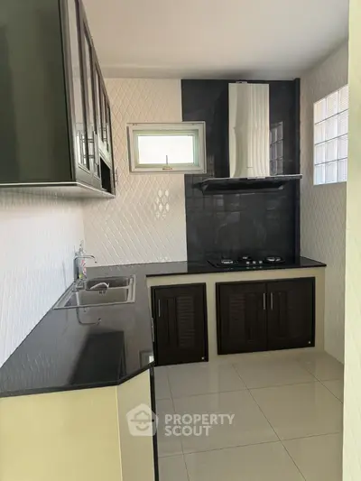 Modern kitchen with sleek black countertops and gas stove