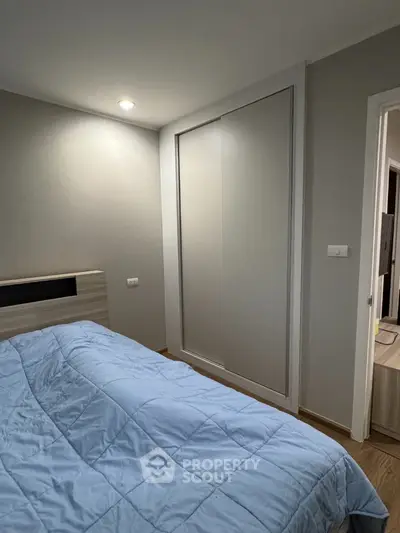 Cozy bedroom with modern sliding closet and soft blue bedding