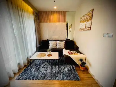Cozy living room with modern decor, plush sofa, and elegant rug in a bright apartment.