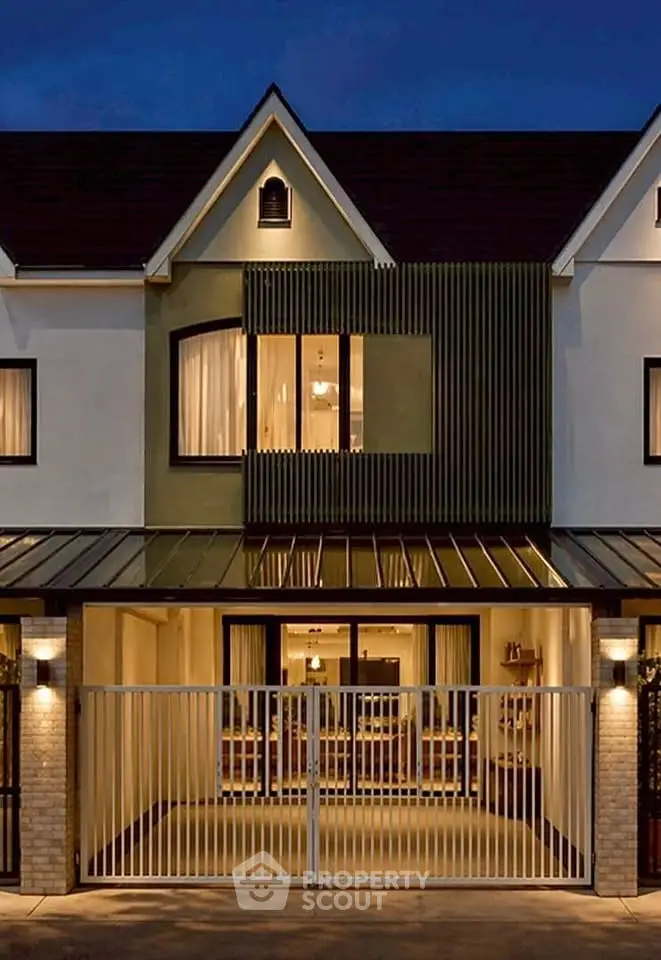 Charming modern townhouse with stylish facade and warm lighting, perfect for cozy living.