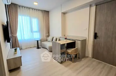 Modern living room with stylish furniture and natural light, perfect for relaxation and entertainment.