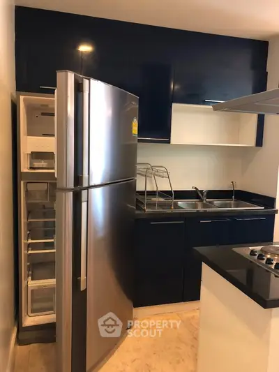 Modern kitchen with sleek stainless steel fridge and stylish cabinetry