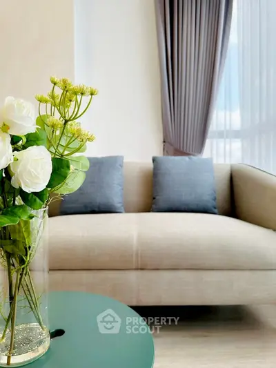 Elegant living room with modern sofa and floral decor, perfect for stylish urban living.