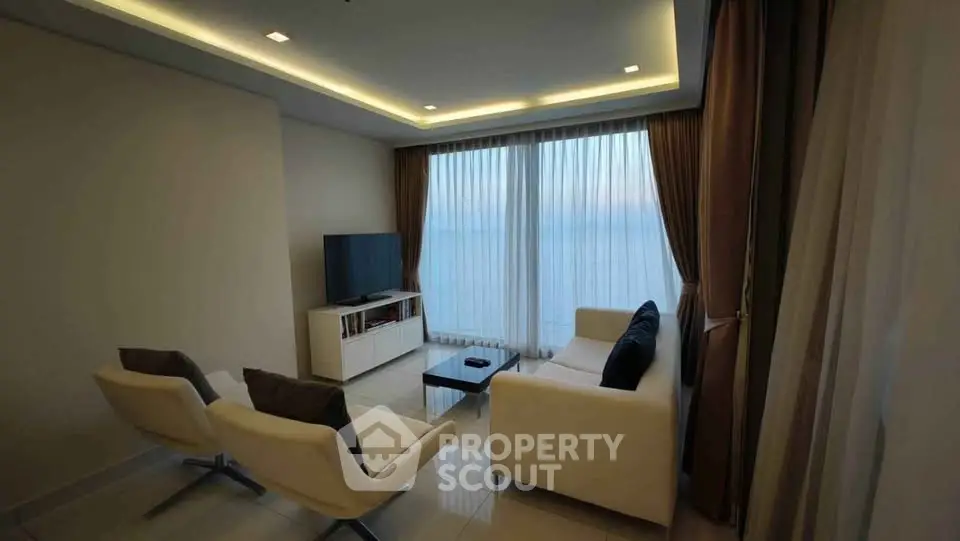 Modern living room with elegant furniture and large windows offering stunning views.