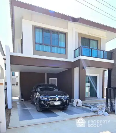 Modern two-story house with carport and sleek design