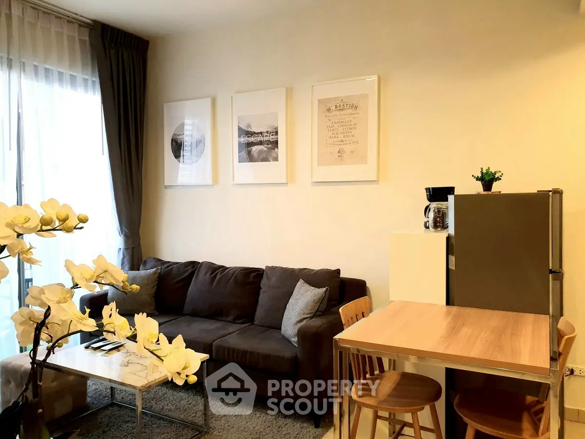 Modern living room with cozy sofa and dining area, featuring stylish decor and natural light.
