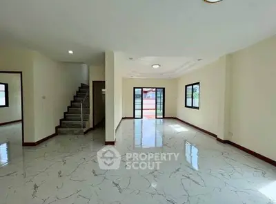 Spacious modern living room with marble flooring and ample natural light