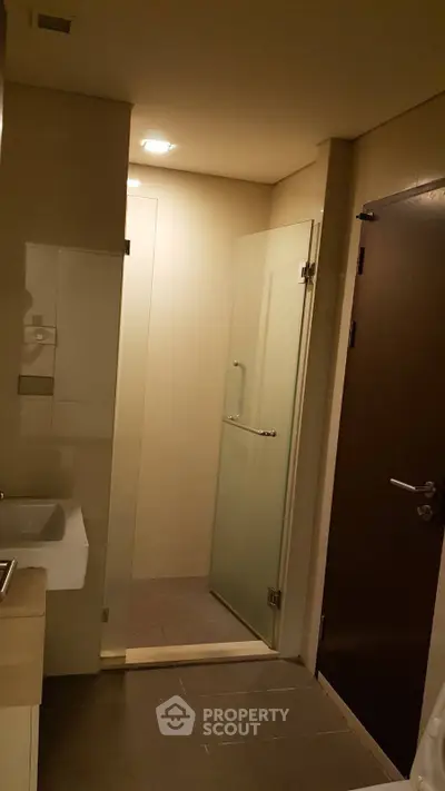 Modern bathroom with glass shower door and sleek fixtures