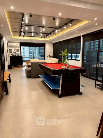 Luxurious living room with pool table and modern decor in high-rise apartment.