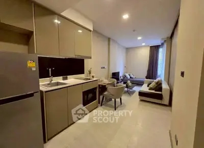 Modern open-plan kitchen and living room with sleek design and neutral tones.