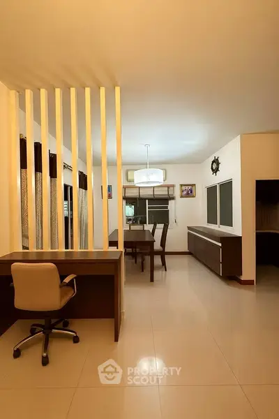 Spacious modern living area with sleek furniture and elegant lighting