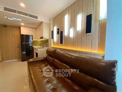 Modern living room with leather sofa and stylish lighting in a contemporary apartment.