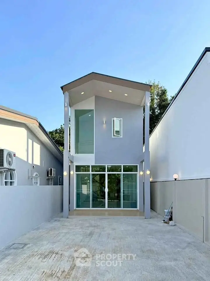 Modern two-story house with sleek design and spacious driveway