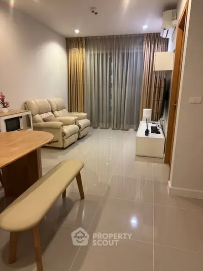 Modern living room with sleek furniture and elegant curtains, perfect for cozy evenings.