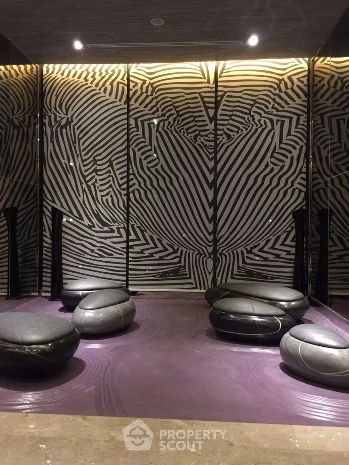 Luxurious modern lobby with artistic wall design and stylish seating