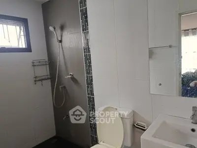 Modern bathroom with sleek shower and white fixtures