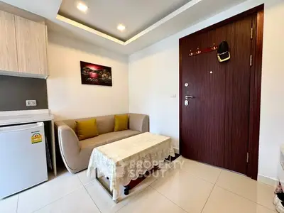 Cozy living room with modern decor and compact furniture in a stylish apartment.