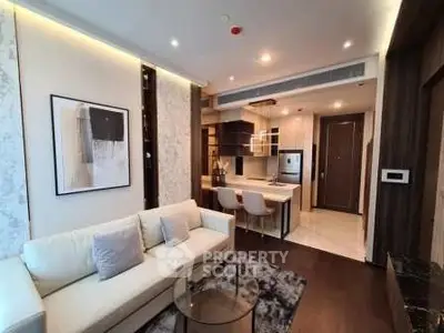 Modern living room with open kitchen, stylish decor, and cozy seating area in a luxury apartment.