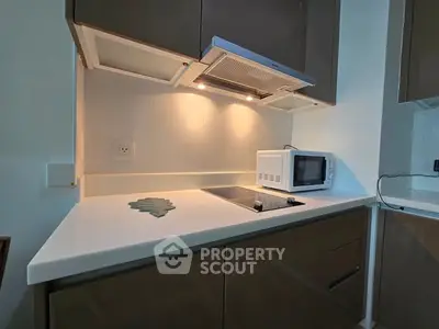 Modern kitchen with sleek cabinetry and built-in microwave