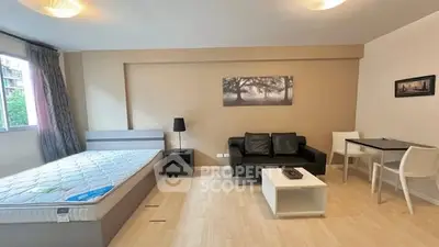 Modern studio apartment with cozy living area and natural light