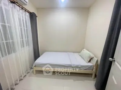 Cozy minimalist bedroom with natural light and neutral tones