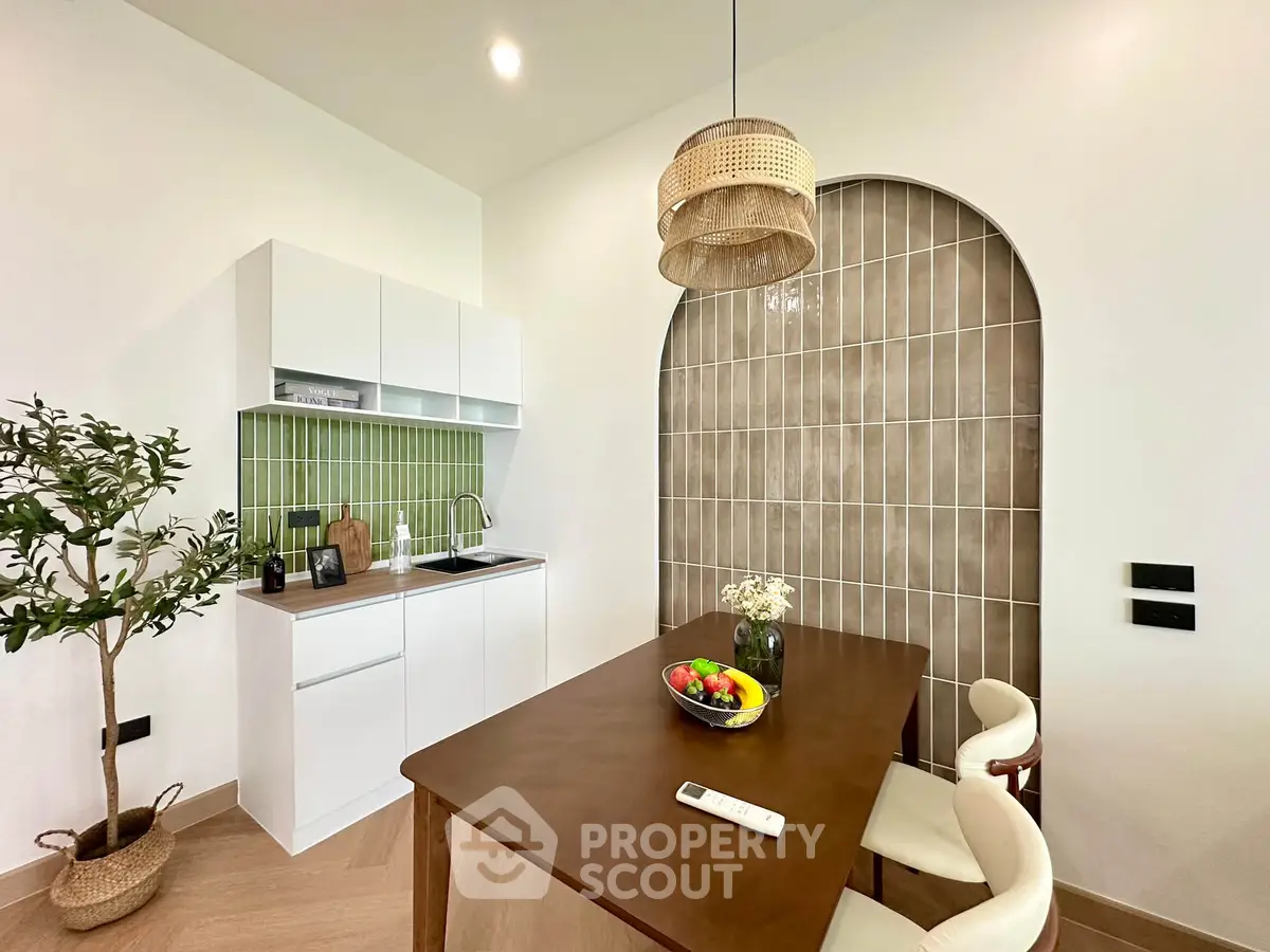 Chic modern kitchen with green backsplash and stylish dining area
