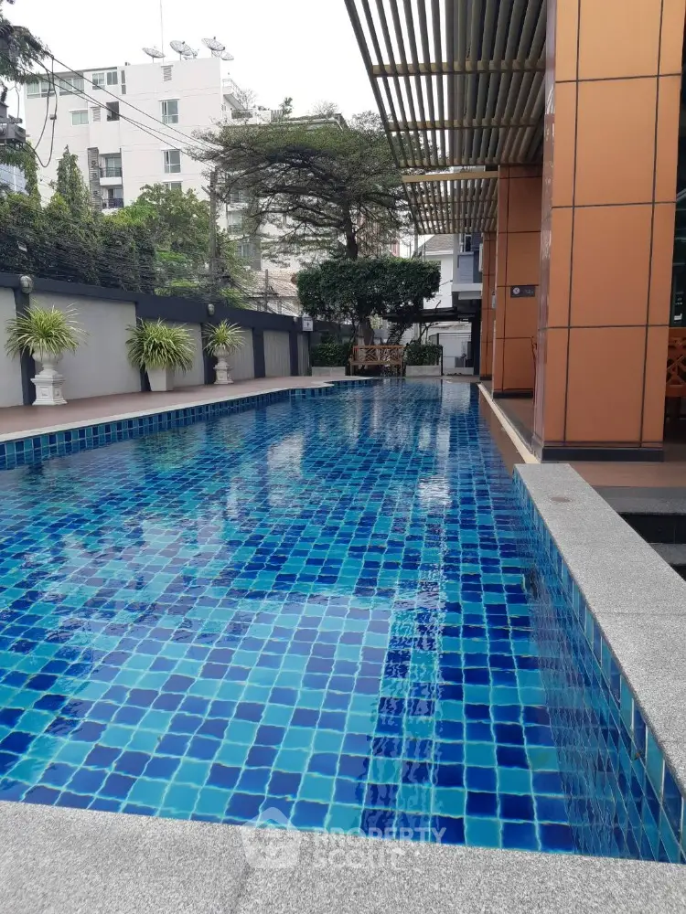 Luxurious outdoor swimming pool with modern design and lush greenery
