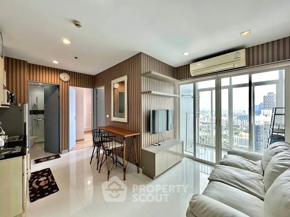 Modern living room with city view, open layout, and stylish decor in high-rise apartment.