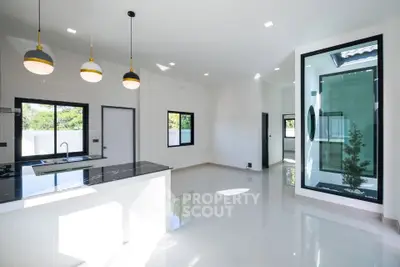 Modern open-plan kitchen with sleek design and ample natural light