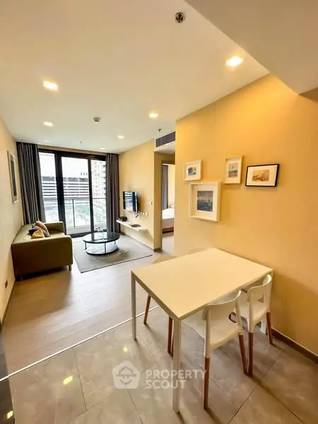Modern open-plan living room with stylish decor and city view.