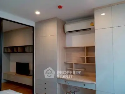 Modern bedroom with built-in desk and air conditioning unit