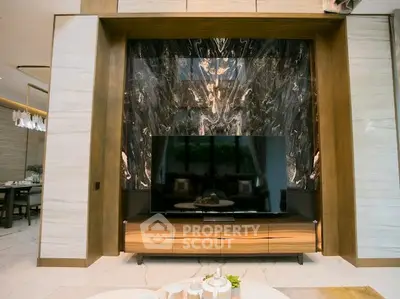 Luxurious living room with elegant marble feature wall and modern TV setup