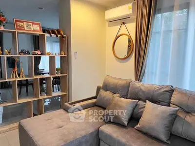 Cozy living room with modern decor and comfortable gray sofa, perfect for relaxation.