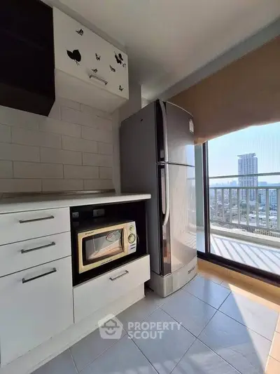 Modern kitchen with sleek appliances and city view from balcony