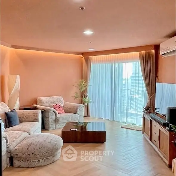 Spacious living room with modern decor and large windows offering city views.