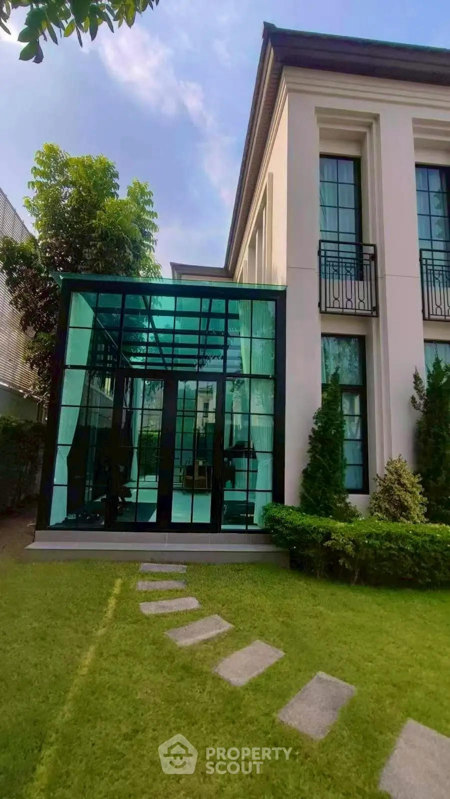 Elegant modern house with glass extension and lush garden