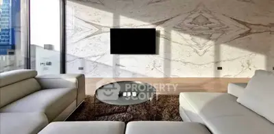 Luxurious modern living room with sleek furniture and marble accent wall