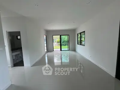 Spacious modern living room with large windows and garden view